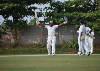 Biplab Samantray raises his bat after completing century against Haryana in Bhubaneswar, Sunday    