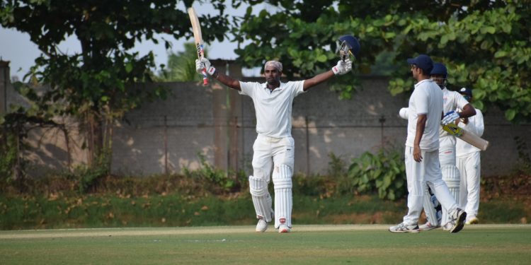 Biplab Samantray raises his bat after completing century against Haryana in Bhubaneswar, Sunday    