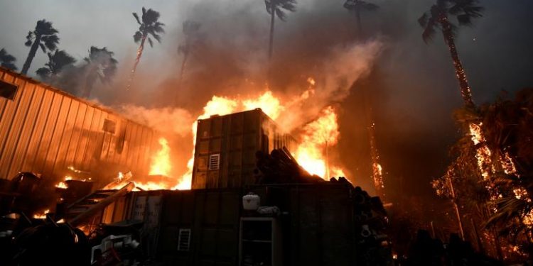 A home is engulfed in flames during the Woolsey Fire in Malibu, California, Friday. REUTERS