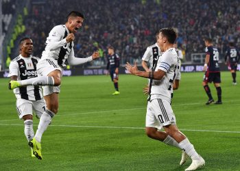 Paulo Dybala (R) celebrates with his teammates after scoring the opener for Juventus against Cagliari, Saturday 