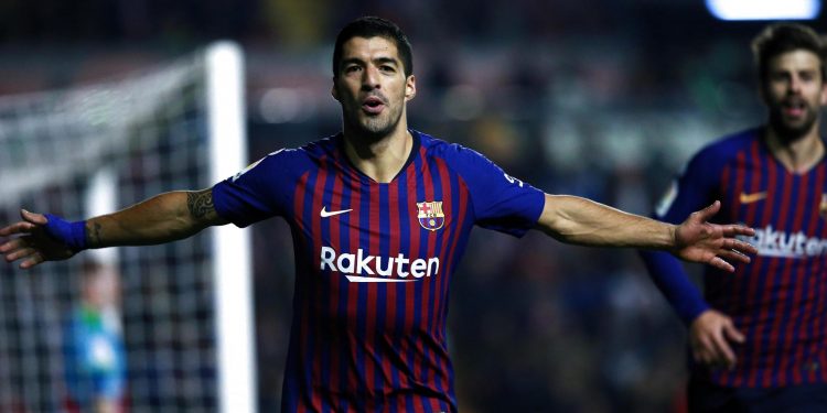 Luis Suarez celebrates after netting the winner against Rayo Vallecano, Saturday