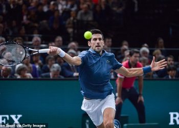 Novak Djokovic stretches to play a shot against Roger Federer in Paris, Saturday   