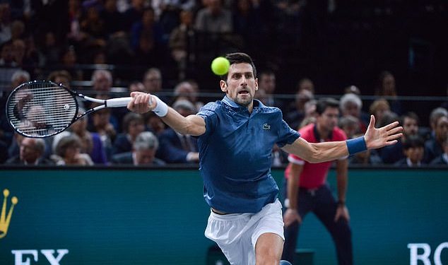 Novak Djokovic stretches to play a shot against Roger Federer in Paris, Saturday   