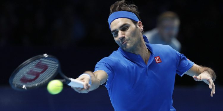 Roger Federer plays a return to Dominic Thiem during their ATP World Tour Finals men's singles match at the O2 arena in London, Tuesday
