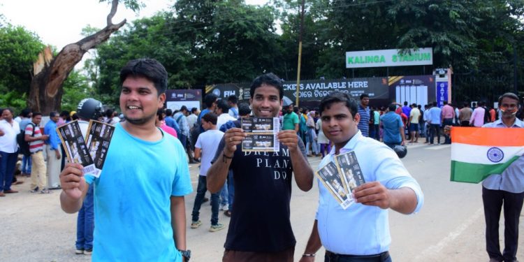 Fans show their tickets in front of a crowdie Gate No.9 of the Kalinga Stadium in Bhubaneswar, Monday 