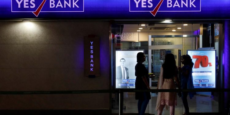 Employees enter a Yes Bank branch at its headquarters in Mumbai, January 17, 2018. REUTERS