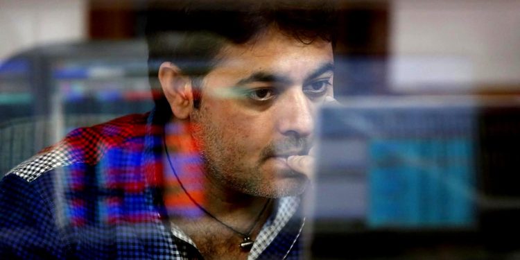 A broker reacts while trading at his computer terminal at a stock brokerage firm in Mumbai, India, February 26, 2016. REUTERS/Shailesh Andrade/Files