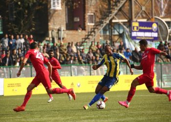 Real Kashmir’s Gnohere Krizo (C) tries to go past Churchill Brothers’ defenders during the I-League encounter in Srinagar, Tuesday