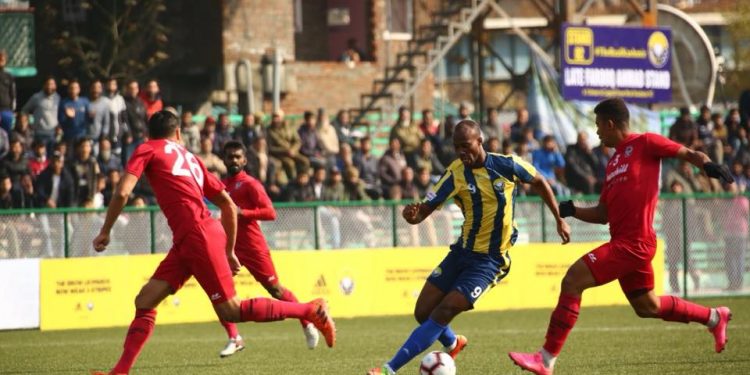 Real Kashmir’s Gnohere Krizo (C) tries to go past Churchill Brothers’ defenders during the I-League encounter in Srinagar, Tuesday