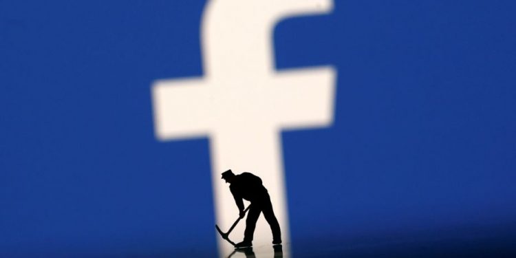 FILE PHOTO: Figurines are seen in front of the Facebook logo in this illustration taken March 20, 2018. (REUTERS)