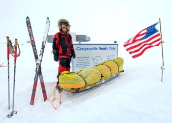American adventurer Colin O'Brady poses for a photo at the Geographic South Pole sign in Antarctica (AFP)