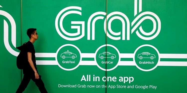 FILE PHOTO: A man walks past a Grab office in Singapore March 26, 2018. (REUTERS)