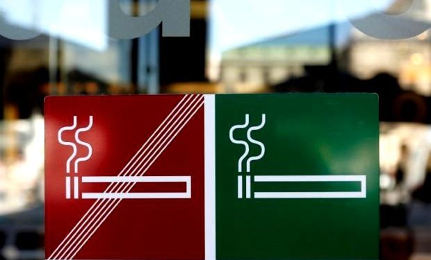 No smoking signs on a cafe establishment door.