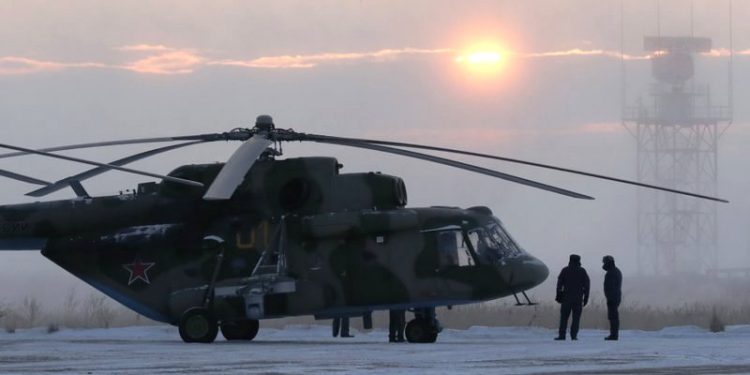 A search and rescue helicopter are seen before a flight to the landing area of the Soyuz MS-09 capsule with the International Space Station (ISS) crew onboard during sunrise in the town of Zhezkazgan, formerly known as Dzhezkazgan, Kazakhstan, Thursday, Dec. 20, 2018. (AP)
