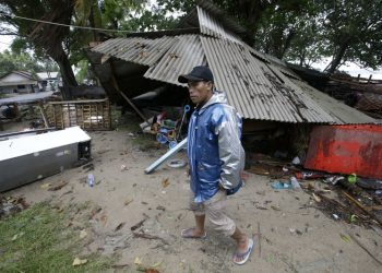 A man inspects his house damaged by a tsunami in Carita, Indonesia, Sunday, Dec. 23, 2018. The tsunami occurred after the eruption of a volcano around Indonesia's Sunda Strait during a busy holiday weekend, sending water crashing ashore and sweeping away hotels, hundreds of houses and people attending a beach concert. (AP)