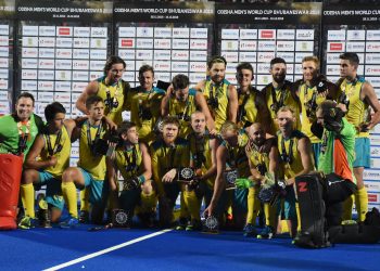 Australian players celebrate with their bronze medals at the Kalinga Stadium, Sunday