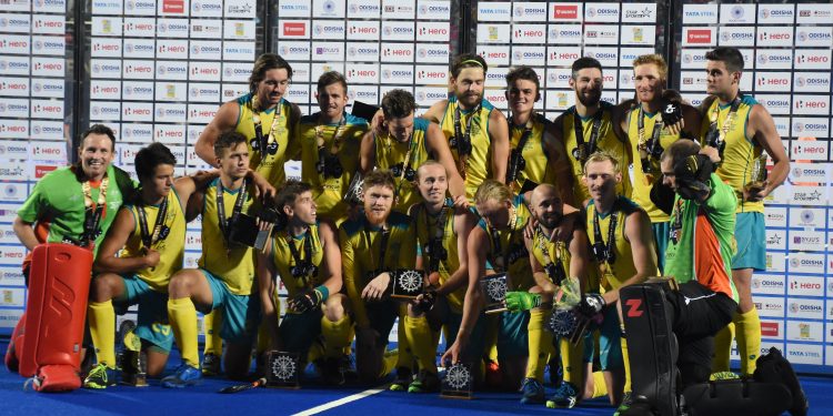 Australian players celebrate with their bronze medals at the Kalinga Stadium, Sunday
