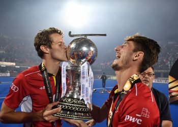 Belgian players celebrate with the hockey World Cup Sunday