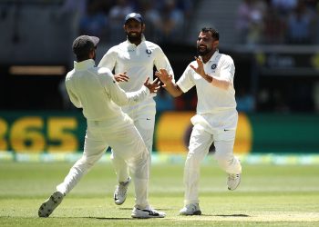 Mohammed Shami (R) and skipper Virat Kohli celebrate after an Australian wicket as Hanuma Vihari rushes on to join them at Perth, Monday