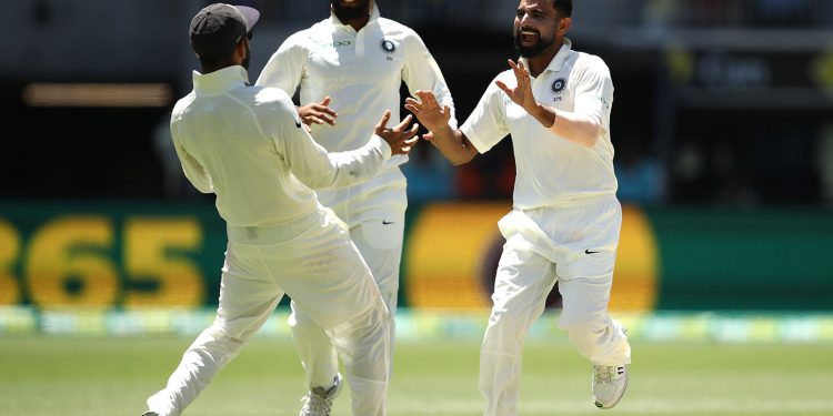 Mohammed Shami (R) and skipper Virat Kohli celebrate after an Australian wicket as Hanuma Vihari rushes on to join them at Perth, Monday