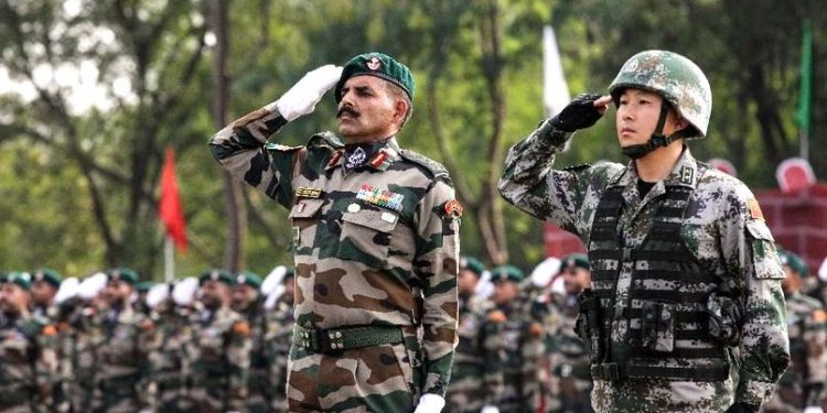 Indian and Chinese soldiers salute at the starting ceremony of the Hand-in-hand India-China Anti-Terrorism Joint Training Exercise in Pune, India, on Nov. 17, 2014. (PTI)