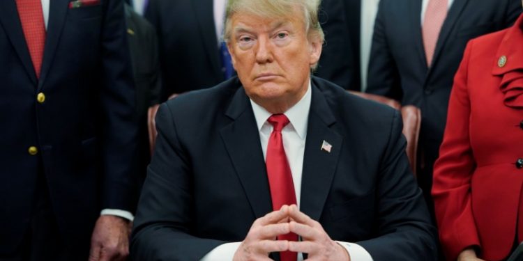 U.S. President Donald Trump listens to questions from reporters about an impending U.S. Government shutdown as he participates in a bill signing ceremony for the “First Step Act” and the “Juvenile Justice Reform Act” in the Oval Office of the White House in Washington, U.S., December 21, 2018.   (REUTERS/Joshua Roberts)
