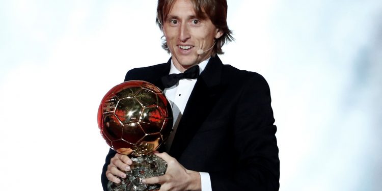 Luka Modric poses with the Ballon d'Or trophy at Paris