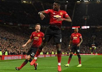 Manchester United’s Paul Pogba (C) leaps high in celebration after scoring one of his two goals against Bournemouth while teammates Ander Herrera (L) and Ashley Young join in at Old Trafford Sunday