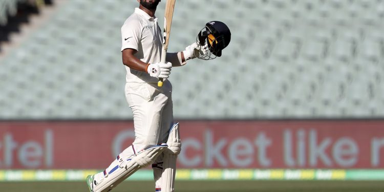 Cheteshwar Pujara celebrates after reaching a century against Australia in Adelaide