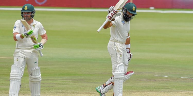 Hashim Amla raises his bat after reaching fifty while Dean Elgar applauds against Pakistan in Centurion, Friday

         