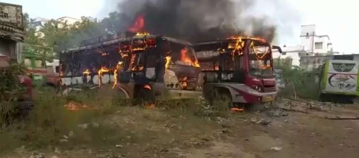Two parked buses catch fire