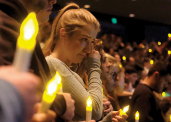 Mourners at a vigil for wildfire loss.
