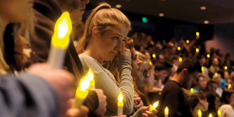 Mourners at a vigil for wildfire loss.