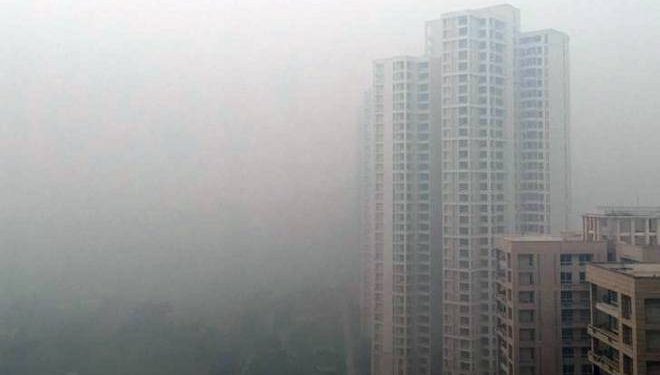 A residential building is shrouded in smog in New Delhi, India, December (REUTERS)