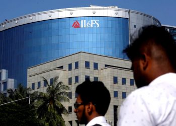 People walk past a building of IL&FS (Infrastructure Leasing and Financial Services Ltd.) outside its headquarters in Mumbai, India, September 25, 2018. REUTERS