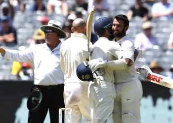 India's batsman Cheteshwar Pujara (R) celebrates reaching his century (100 runs) with teammate Virat Kohli during day two of the third cricket Test match between Australia and India in Melbourne on December 27, 2018. (AFP)
