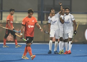 Pakistan players (in white) celebrate after scoring against Malaysia at the Kalinga Stadium, Wednesday
