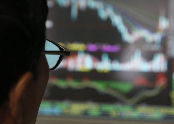A man examines stock update on a display at stock brokerage in Beijing, China, Monday, Oct. 6, 2018 (AP)