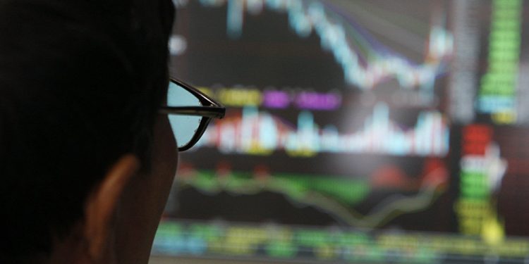 A man examines stock update on a display at stock brokerage in Beijing, China, Monday, Oct. 6, 2018 (AP)