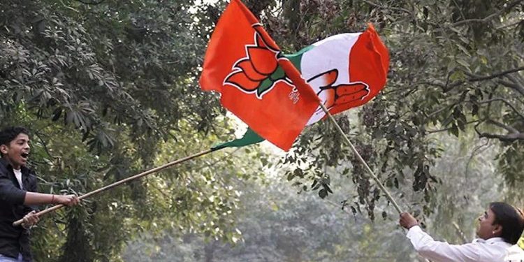 Supporters of BJP and Congress get into flag fight as the party candidates were filing their nomination papers at DC office Geeta Colony on November 13, 2013 in New Delhi, India. (AFP/Getty Images)