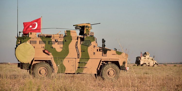 In this photo taken 1 November 2018, Turkish and U.S. troops conduct joint patrols around the Syrian town of Manbij as a part of an agreement that aimed to ease tensions between the two NATO allies (AP)