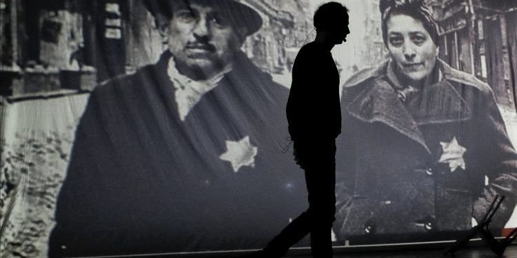 An actor of the Romania's Jewish State Theatre rehearse the musical drama "The Lights of the Ghetto" a mix of music and stories by Holocaust survivors in Bucharest, Romania, Saturday, Jan. 26, 2019, a day before the premiere on International Holocaust Remembrance Day. About 280,000 Romanian Jews and 11,000 Romanian Roma, or Gypsies, were deported and killed during WWII when Romania was ruled by a pro-nazi regime. (AP)