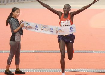 Mumbai: Lagat of Kenya cuts the tape to win the Mumbai Marathon 2019 as boxer Mary Kom receives her at the finishing line in Mumbai, Sunday, Jan 20, 2019. (PTI)