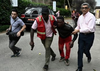 Nairobi attack: An injured man is evacuated from the Dusit2 hotel and office complex (AFP)