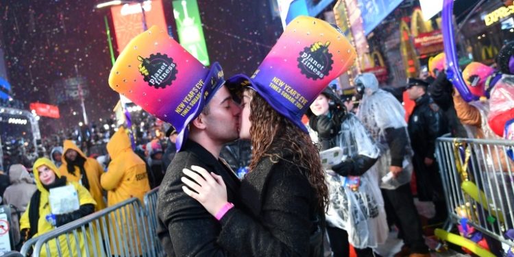 Fireworks exploded overhead and couples kissed as revelers welcomed the New Year in New York City's Times Square