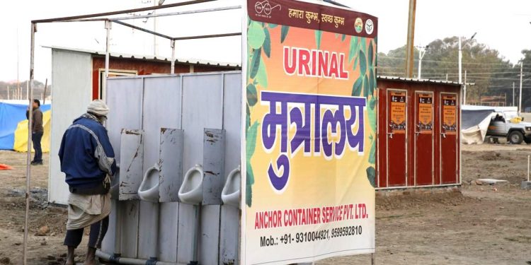 A devotee uses a newly established portable toilet in Kumbh Mela 2019 (AP)