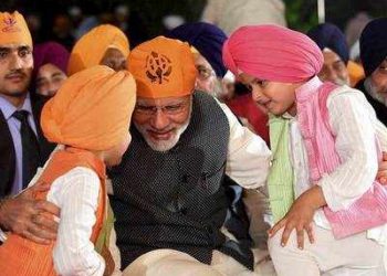 PM Modi interacts with children at a function to mark the birth anniversary of Guru Nanak (PTI)