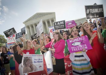 In this 2014 photo, demonstrators react to hearing the Supreme Court's decision on the Hobby Lobby birth control case outside the Supreme Court in Washington. A judge in California has blocked implementation of a Trump administration policy that would let more employers decline to offer birth control coverage on religious or moral grounds.