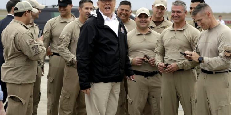 President Donald Trump turns as he talks to U.S. Customs and Border Protection officers at McAllen International Airport as he prepares to leave after a visit to the southern border, Thursday, Jan. 10, 2019, in McAllen, Texas. (AP)