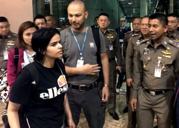 In this Jan. 7, 2019, file photo released by the Immigration Bureau, Saudi woman Rahaf Mohammed Alqunun, foreground, walks by Chief of Immigration Police Maj. Gen. Surachate Hakparn, right, before leaving the Suvarnabhumi Airport in Bangkok, Thailand. Australia says it is considering granting the Saudi who fled from her family refugee resettlement based on referral by the U.N. (AP)